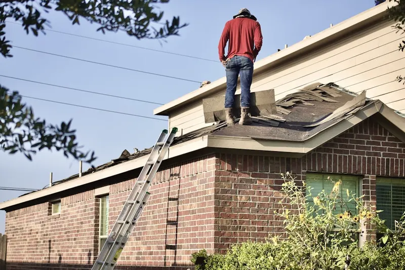 Professional roofer working on a residential roof in Southwest Loveland - Thompson